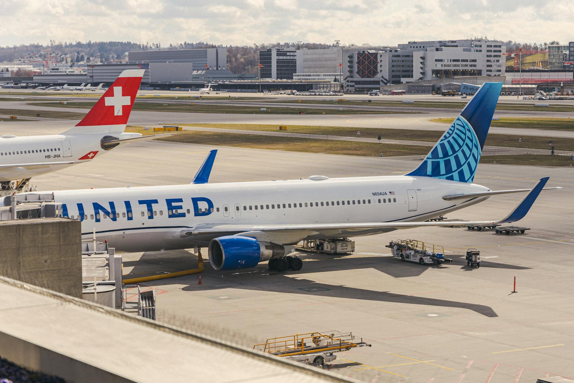 Zurich Airport aircraft at terminal context for deal team travel report planning.