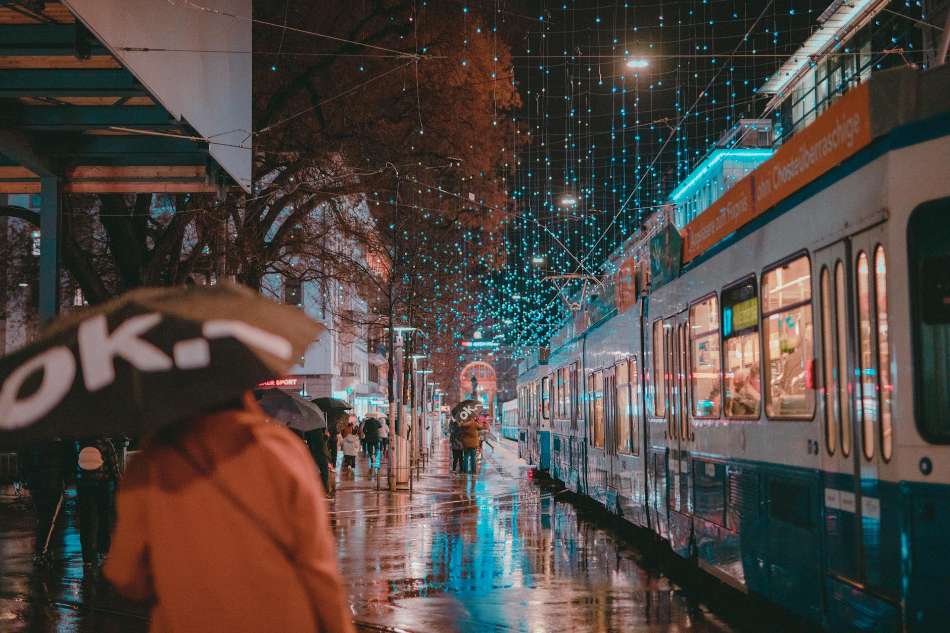 Rainy Zurich night tram street context for nightlife district planning.