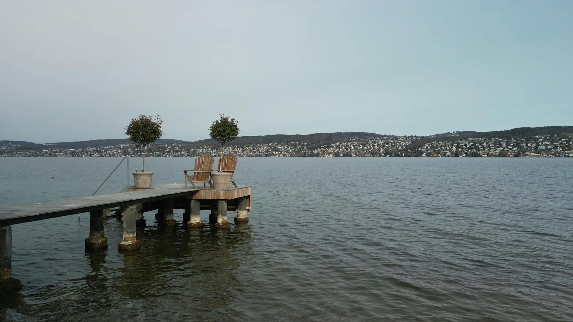 Lake Zurich pier and seating context for older traveler hotel planning.