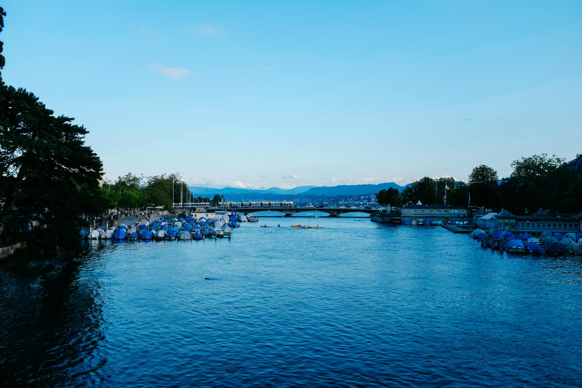 Zurich river and moored boats context for lower-friction scenic planning.