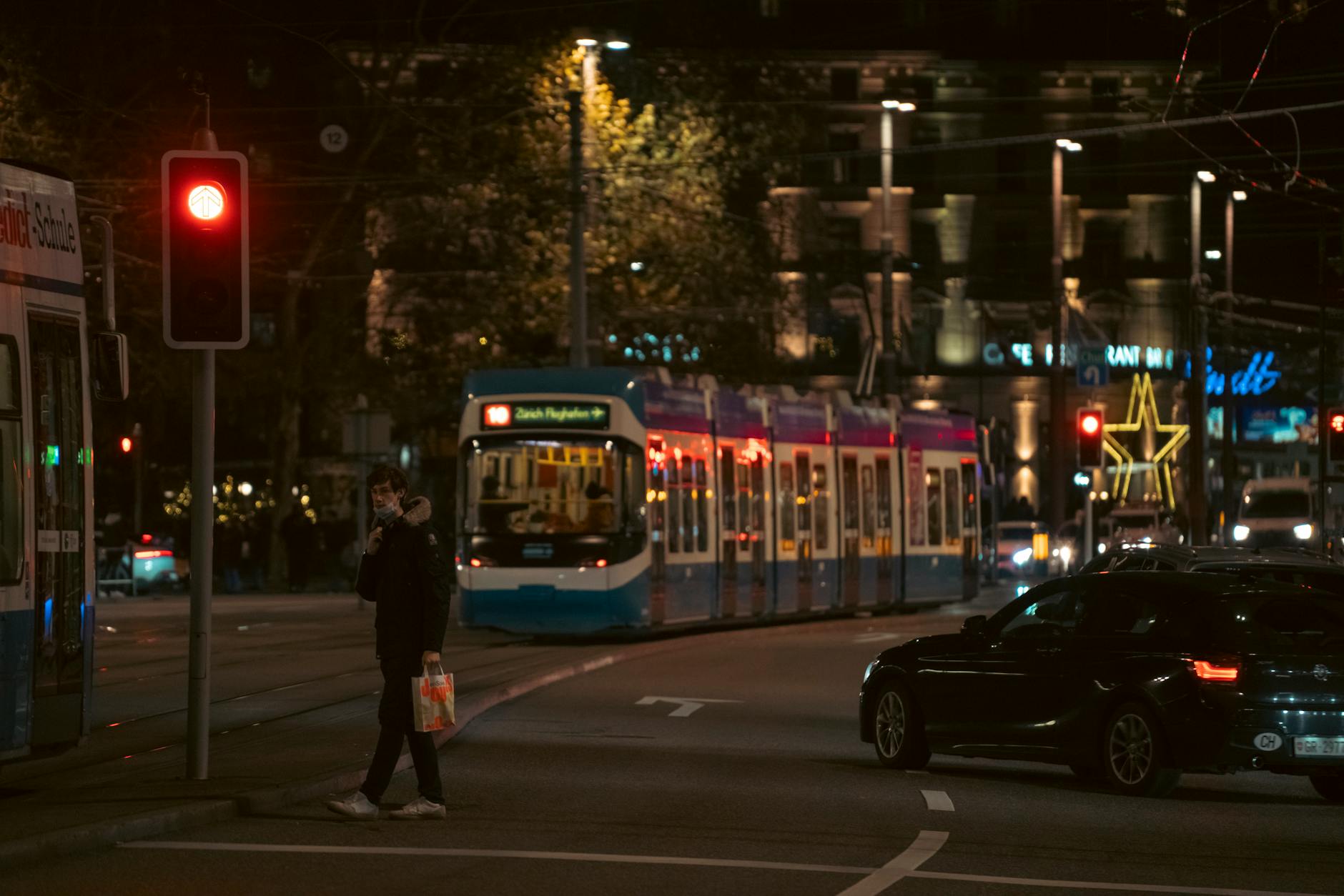 Zurich night tram and crosswalk context for evening route planning.