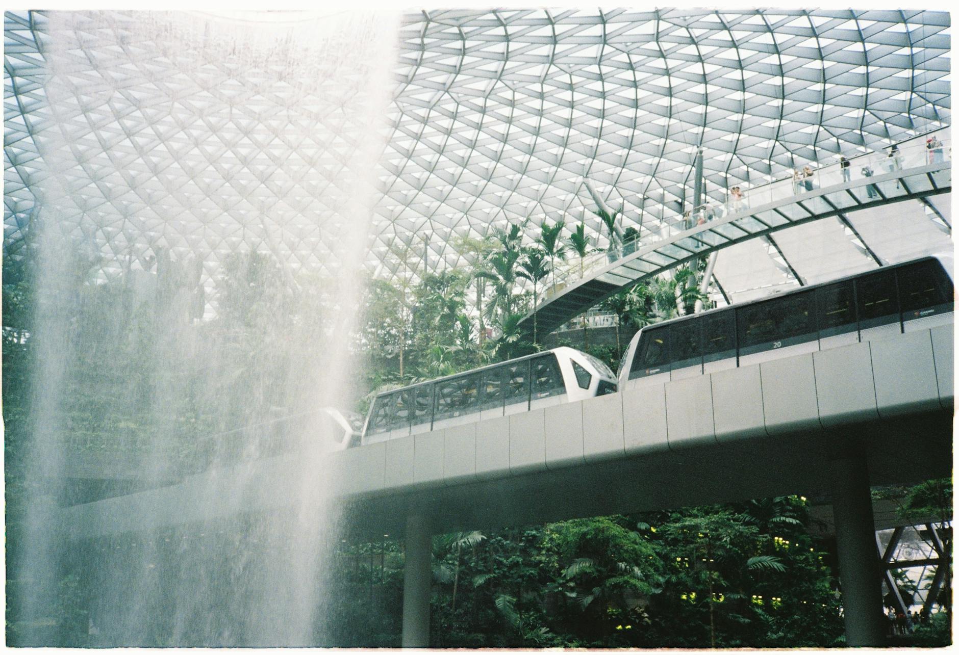 Train passing the waterfall inside Jewel Changi Airport.