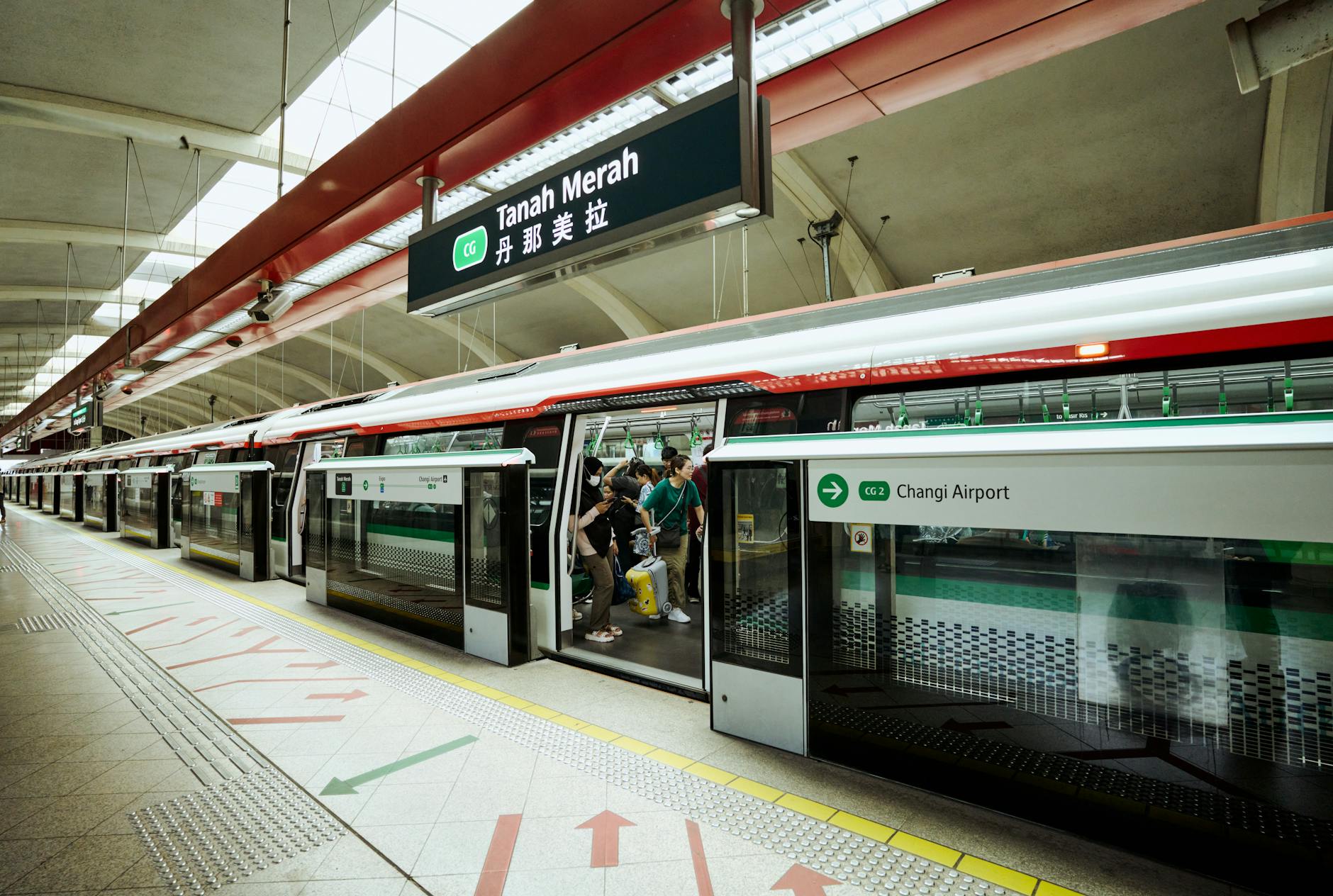 Commuters boarding an MRT train at Tanah Merah station.
