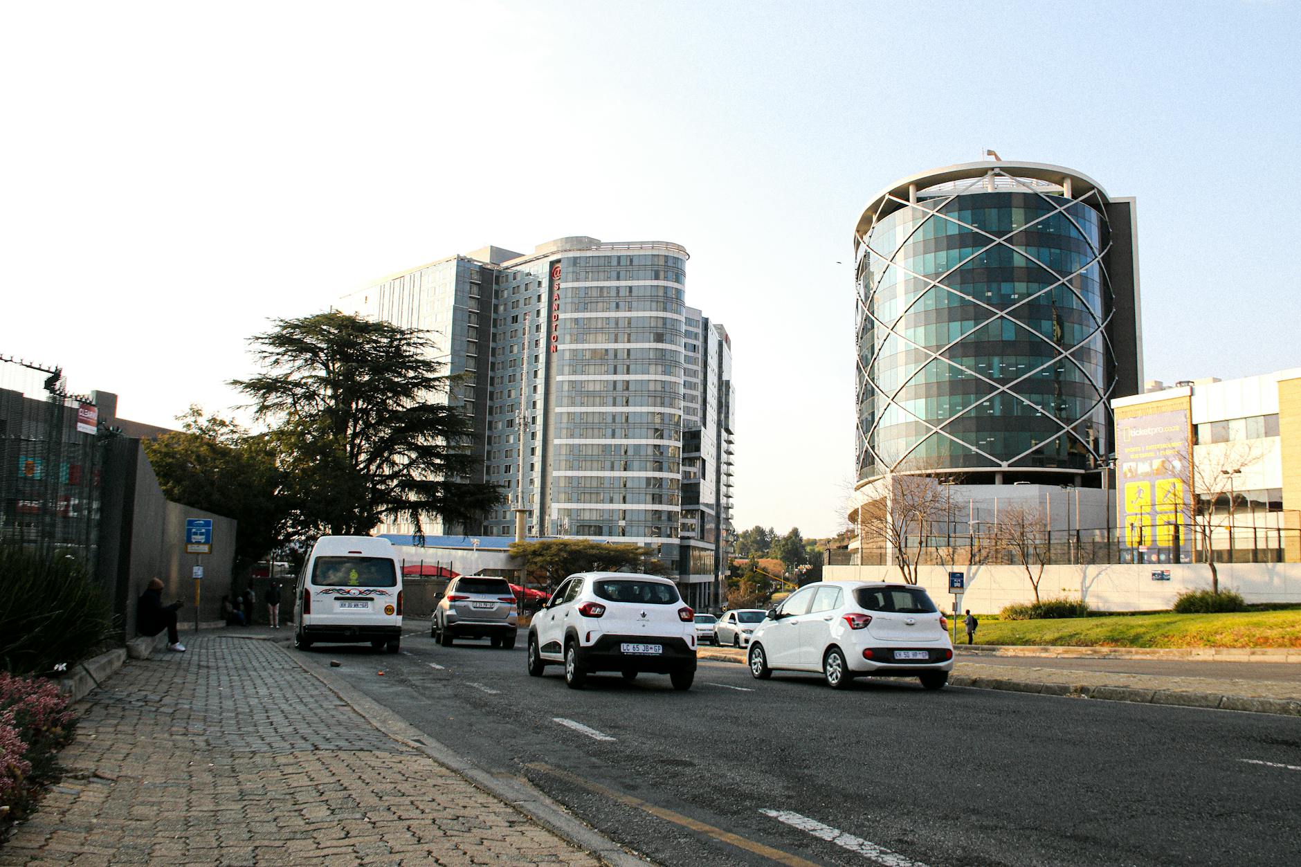 Johannesburg street traffic among modern office buildings.