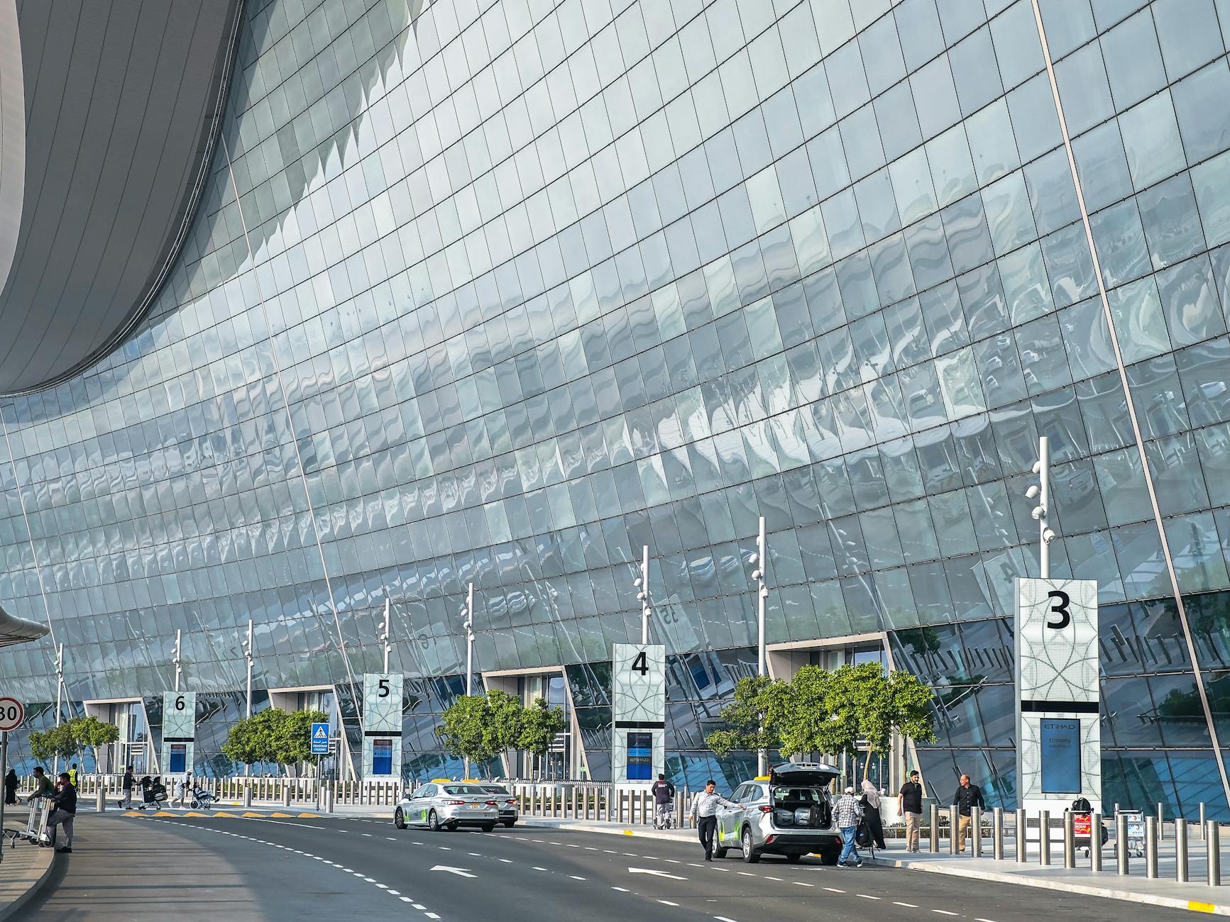 Glass airport terminal exterior in the United Arab Emirates.